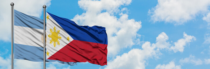 Argentina and Philippines flag waving in the wind against white cloudy blue sky together. Diplomacy concept, international relations.