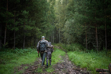 father pointing and guiding son on first deer hunt - obrazy, fototapety, plakaty