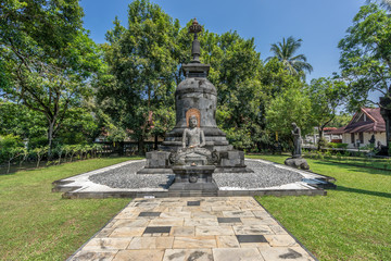 Fototapeta premium Buddha stone statue in the Bhumisparsha Mudra or gesture. Mendut Buddhist Monastery (Vihara Mendut). Located next to Mendut Temple, Mungkid Town, Central Java.