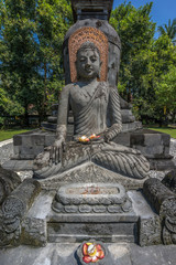 Buddha stone statue in the Bhumisparsha Mudra or gesture. Mendut Buddhist Monastery (Vihara Mendut). Located next to Mendut Temple, Mungkid Town, Central Java.