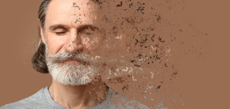 Crumbling Mature Man On Color Background. Process Of Aging