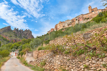 Fototapeta premium Colorful landscape view of the town of Ayna and the Picarzos rock from the bottom of the mundo river valley, Albacete province, Castilla la Mancha, Spain