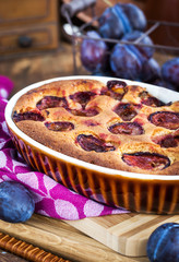 Fresh homemade dimply plum cake on rustic background