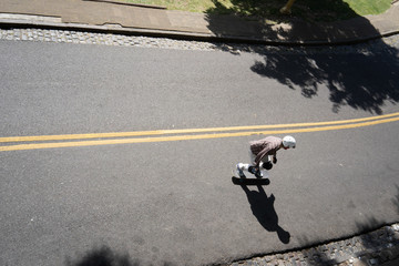 young people descend through the streets of a city square by skate