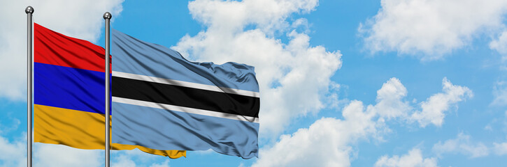 Armenia and Botswana flag waving in the wind against white cloudy blue sky together. Diplomacy concept, international relations.