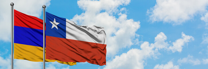 Armenia and Chile flag waving in the wind against white cloudy blue sky together. Diplomacy concept, international relations.