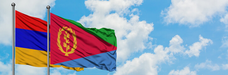 Armenia and Eritrea flag waving in the wind against white cloudy blue sky together. Diplomacy concept, international relations.