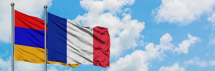 Armenia and France flag waving in the wind against white cloudy blue sky together. Diplomacy concept, international relations.
