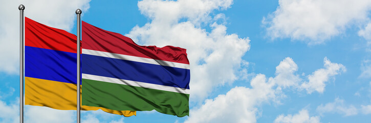 Armenia and Gambia flag waving in the wind against white cloudy blue sky together. Diplomacy concept, international relations.