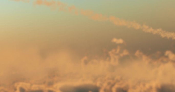 Three fighter jets flying at high speed over the clouds under a sunset leaving behind smoke trails. Alpha channel included, easy compositing to isolate the background of the jets and replace it
