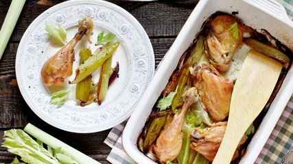 baked chicken pieces with celery stalk. chicken with celery. top view. copy space. keto recipe, low carb