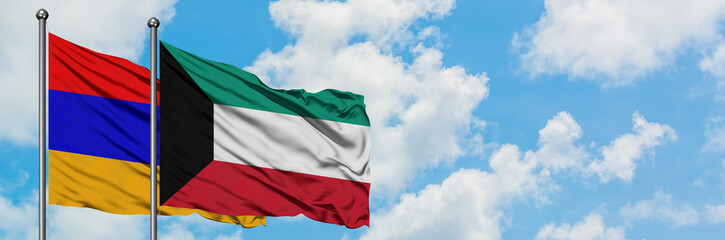 Armenia and Kuwait flag waving in the wind against white cloudy blue sky together. Diplomacy concept, international relations.