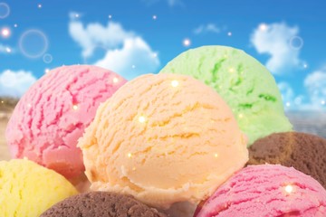 Chocolate, vanilla and strawberry ice cream in the cones on  background