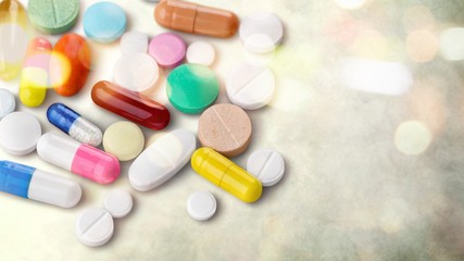 Colorful pills and tablets on background