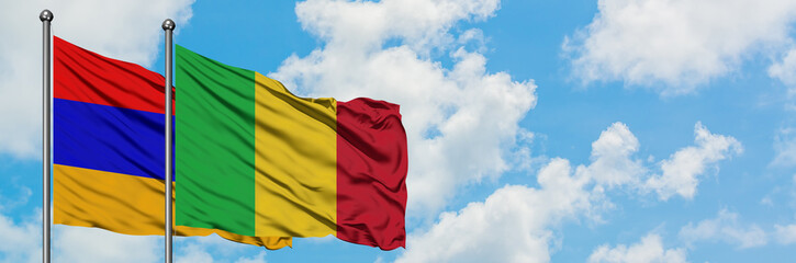 Armenia and Mali flag waving in the wind against white cloudy blue sky together. Diplomacy concept, international relations.