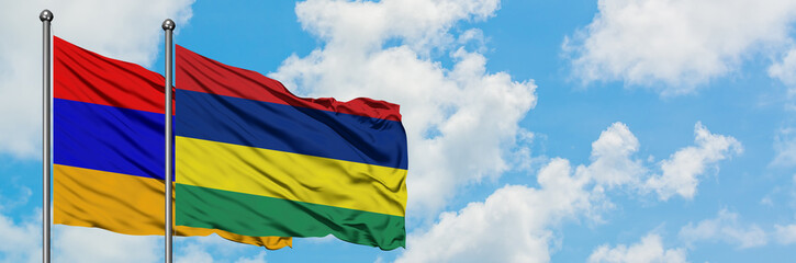Fototapeta na wymiar Armenia and Mauritius flag waving in the wind against white cloudy blue sky together. Diplomacy concept, international relations.