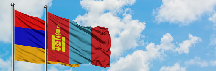 Armenia and Mongolia flag waving in the wind against white cloudy blue sky together. Diplomacy concept, international relations.