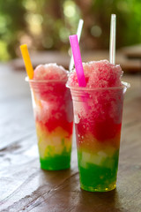 Colorful smoothie ice in a clear glass.