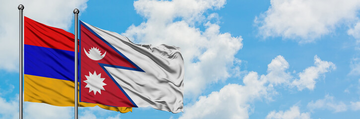 Armenia and Nepal flag waving in the wind against white cloudy blue sky together. Diplomacy concept, international relations.
