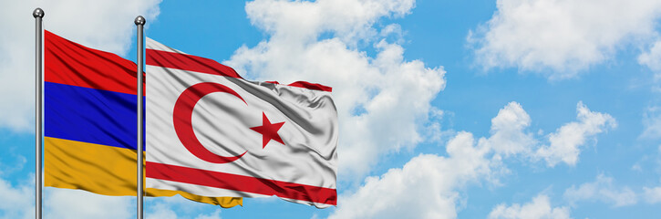 Armenia and Northern Cyprus flag waving in the wind against white cloudy blue sky together. Diplomacy concept, international relations.