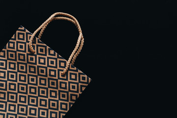 Shopping bag  on black background with copy space.  Black friday concept