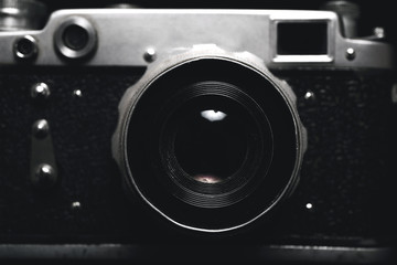 Vintage photo camera in darkness background, close up