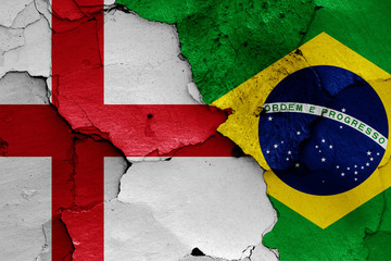 flags of England and Brazil painted on cracked wall
