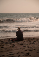 Fototapeta na wymiar Lonely man watching the ocean (verticall)
