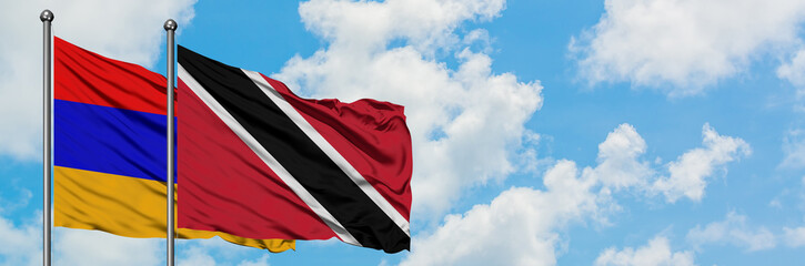 Armenia and Trinidad And Tobago flag waving in the wind against white cloudy blue sky together. Diplomacy concept, international relations.