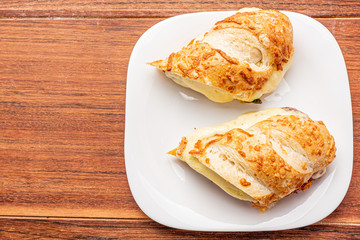 Beef steak sandwich with cheese and tomato, isolated on wooden background