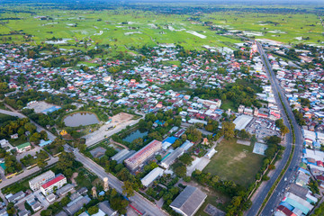 Top view Aerial photo from flying drone over Beautiful green rice field and village from above,Sisaket province,Thailand,ASIA.