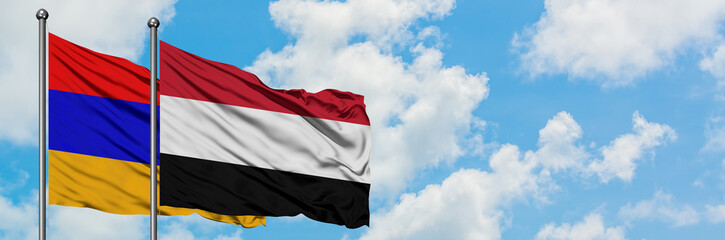Armenia and Yemen flag waving in the wind against white cloudy blue sky together. Diplomacy concept, international relations.