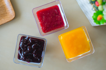 Raspberry ,Orange ,Mixed Berry Jam in The Glasses on The Table