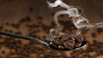 beverage background of roasted coffee beans in spoon with background of blurred background of...