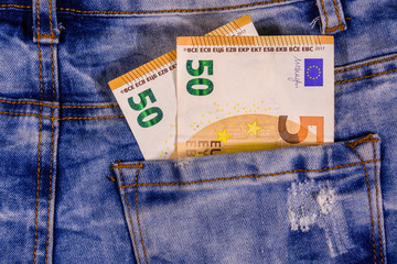 Fifty euro banknotes in pocket of the blue jeans