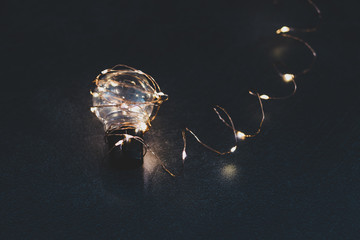 brilliant creativity, idea lightbulb wrapped up in string lights shining all around it and with bokeh