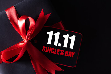 Online shopping of China, 11.11 single's day sale concept. black and red paper tag with ribbon on...