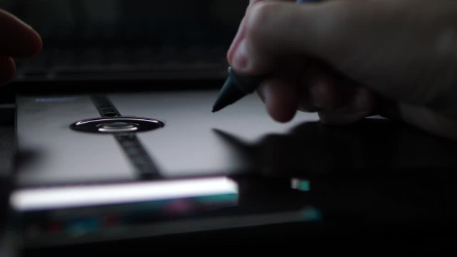 Person Browsing Web with Pen digital graphic Tablet. POV Close up Hands.
