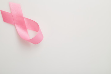 Pink breast cancer ribbon on white