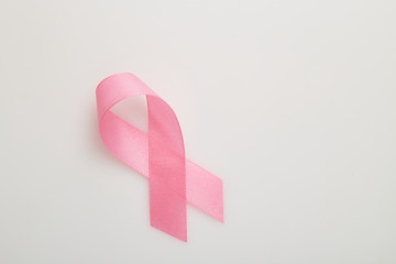 Pink breast cancer ribbon on white