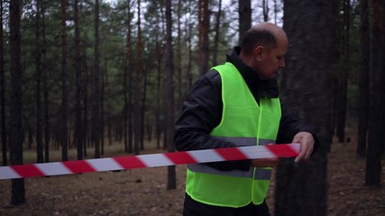 group of volunteers in green vests went in search of missing persons in a pine forest