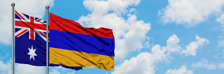 Australia and Armenia flag waving in the wind against white cloudy blue sky together. Diplomacy concept, international relations.