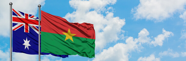 Fototapeta na wymiar Australia and Burkina Faso flag waving in the wind against white cloudy blue sky together. Diplomacy concept, international relations.