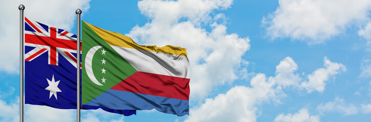 Australia and Comoros flag waving in the wind against white cloudy blue sky together. Diplomacy...