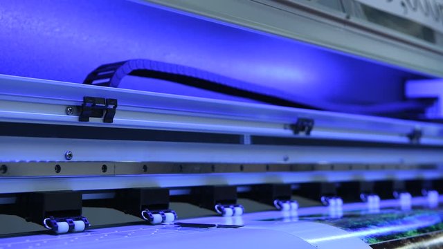 industrial printer moving printhead at work, close up