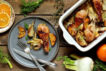 dish with fennel. Baked chicken drumsticks with fennel and oranges. festive dish, popular in the Mediterranean. Keto diet dish. ceramic baking dish. top view. Flatlay