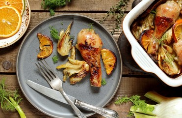 dish with fennel. Baked chicken drumsticks with fennel and oranges. festive dish, popular in the Mediterranean. Keto diet dish. ceramic baking dish. top view. Flatlay