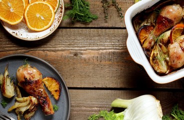 dish with fennel. Baked chicken drumsticks with fennel and oranges. festive dish, popular in the Mediterranean. Keto diet dish. ceramic baking dish. top view. Flatlay