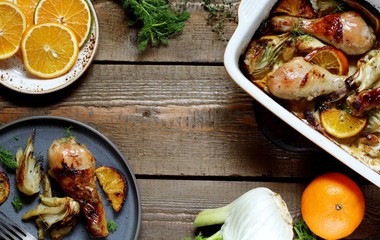 dish with fennel. Baked chicken drumsticks with fennel and oranges. festive dish, popular in the Mediterranean. Keto diet dish. ceramic baking dish. top view. Flatlay