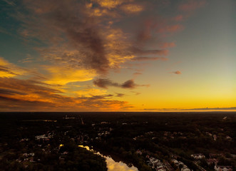 Aerial view over suburban homes and roads early sunrise